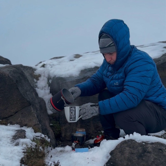 Craig making coffee outdoors in snowy conditions